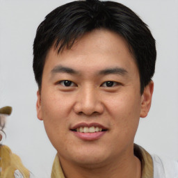 Joyful asian young-adult male with short  brown hair and brown eyes