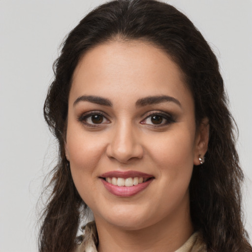 Joyful latino young-adult female with long  brown hair and brown eyes