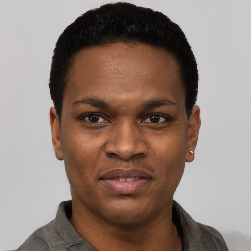 Joyful black young-adult male with short  black hair and brown eyes