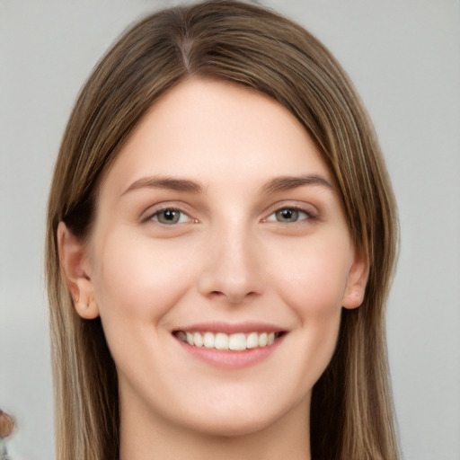 Joyful white young-adult female with long  brown hair and grey eyes