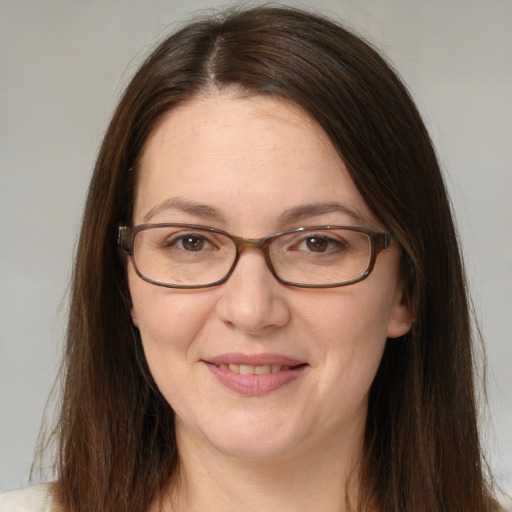 Joyful white adult female with long  brown hair and brown eyes