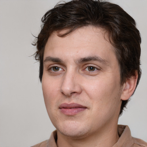 Joyful white young-adult male with medium  brown hair and brown eyes