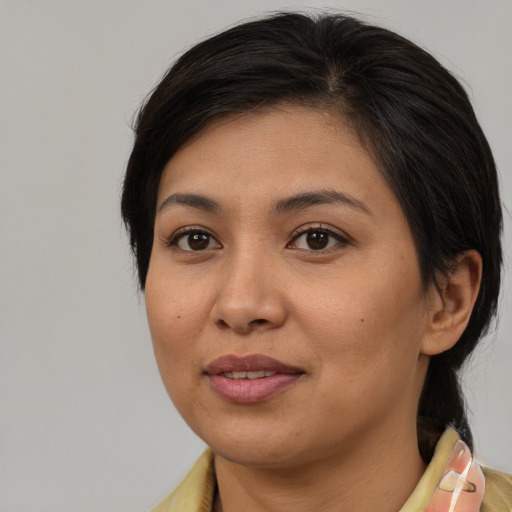 Joyful asian young-adult female with medium  brown hair and brown eyes
