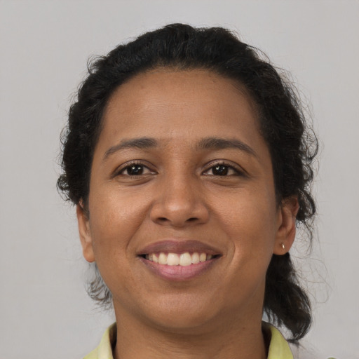 Joyful latino young-adult female with short  brown hair and brown eyes