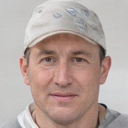 Joyful white adult male with short  brown hair and grey eyes