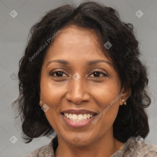 Joyful black adult female with medium  brown hair and brown eyes