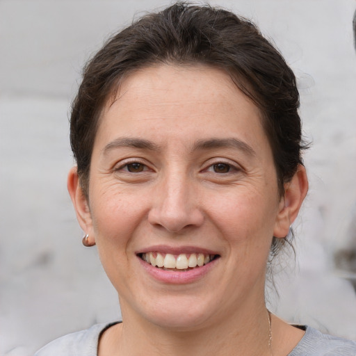 Joyful white adult female with short  brown hair and brown eyes