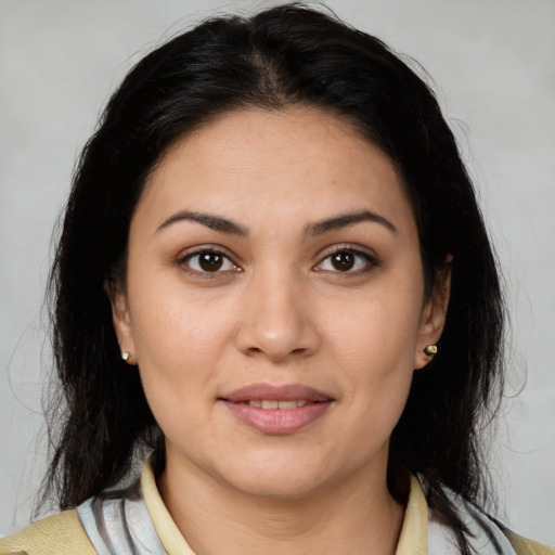 Joyful latino young-adult female with medium  brown hair and brown eyes