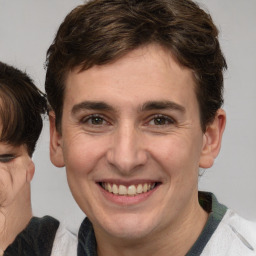 Joyful white adult male with medium  brown hair and brown eyes