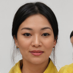 Joyful asian young-adult female with medium  black hair and brown eyes