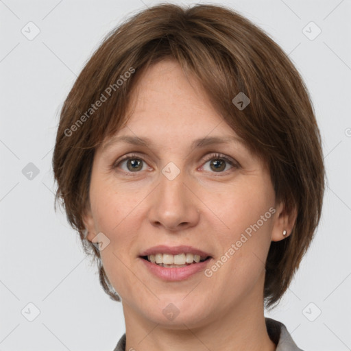 Joyful white adult female with medium  brown hair and grey eyes