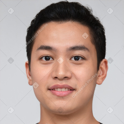 Joyful asian young-adult male with short  brown hair and brown eyes