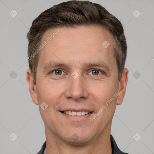 Joyful white adult male with short  brown hair and grey eyes