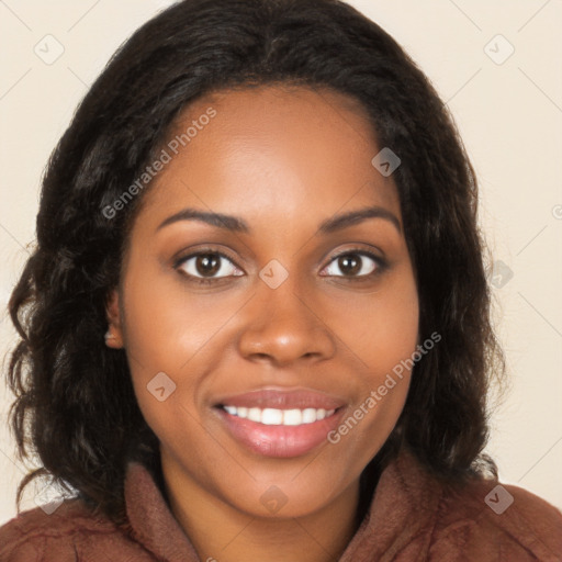 Joyful black young-adult female with long  brown hair and brown eyes