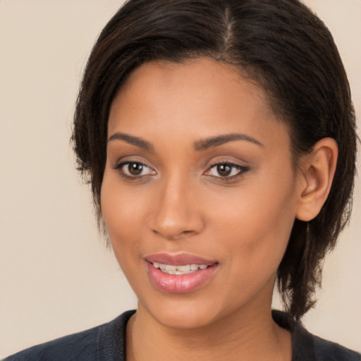 Joyful latino young-adult female with medium  brown hair and brown eyes