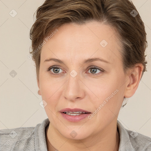 Joyful white adult female with short  brown hair and grey eyes