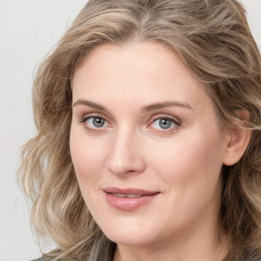 Joyful white young-adult female with medium  brown hair and blue eyes