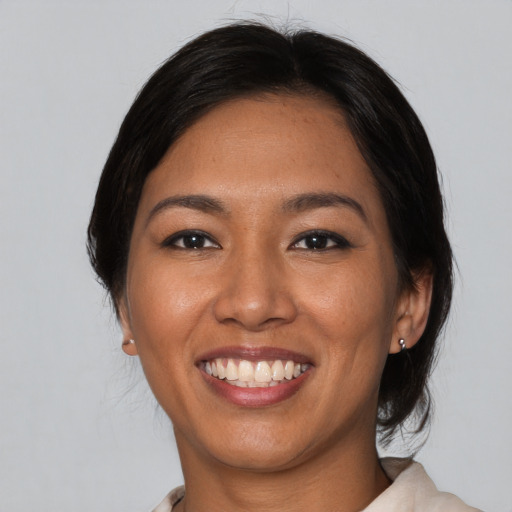 Joyful asian young-adult female with medium  black hair and brown eyes