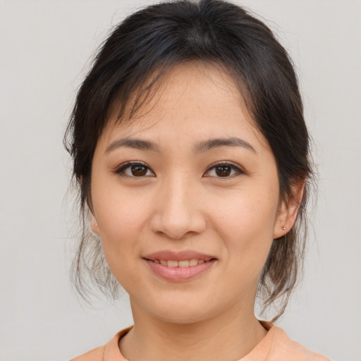 Joyful asian young-adult female with medium  brown hair and brown eyes