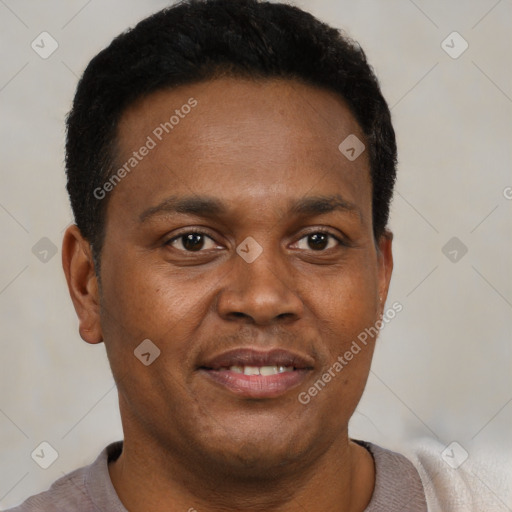 Joyful black young-adult male with short  brown hair and brown eyes