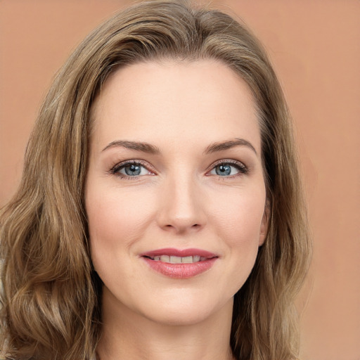 Joyful white young-adult female with long  brown hair and green eyes