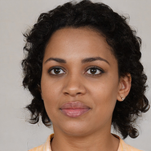 Joyful black young-adult female with medium  brown hair and brown eyes