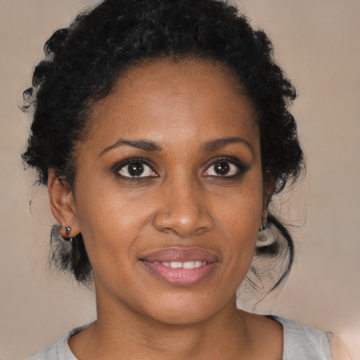 Joyful black young-adult female with medium  brown hair and brown eyes