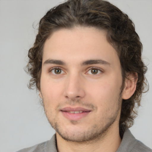 Joyful white young-adult male with medium  brown hair and brown eyes