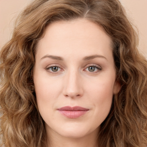 Joyful white young-adult female with long  brown hair and green eyes