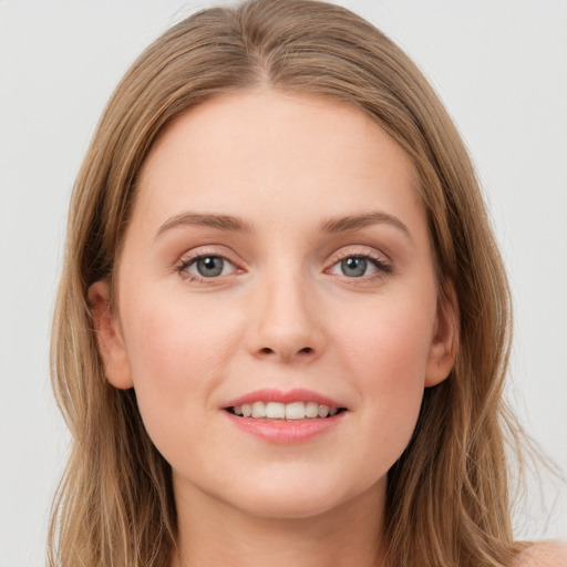 Joyful white young-adult female with long  brown hair and grey eyes