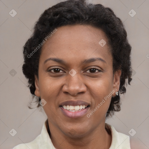 Joyful black adult female with short  brown hair and brown eyes