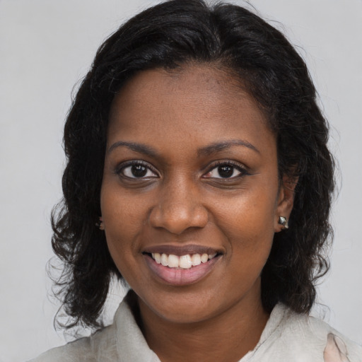 Joyful black young-adult female with medium  brown hair and brown eyes