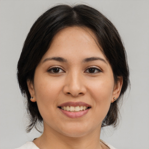 Joyful white young-adult female with medium  brown hair and brown eyes