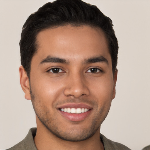 Joyful latino young-adult male with short  black hair and brown eyes