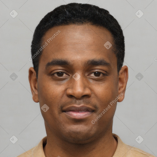 Joyful black young-adult male with short  black hair and brown eyes