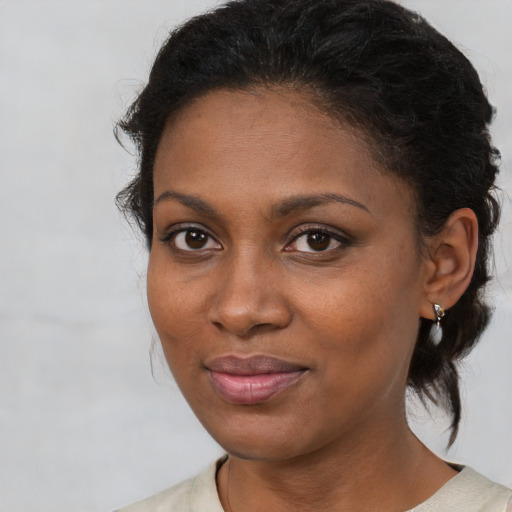 Joyful black young-adult female with medium  brown hair and brown eyes
