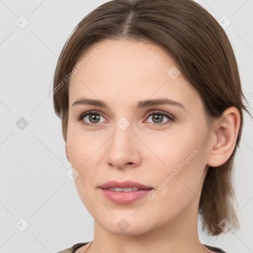 Joyful white young-adult female with medium  brown hair and grey eyes