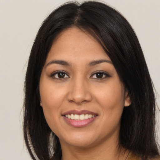 Joyful asian young-adult female with long  brown hair and brown eyes