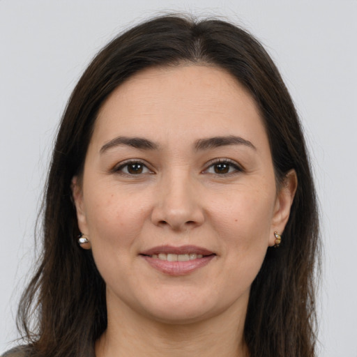 Joyful white young-adult female with long  brown hair and brown eyes