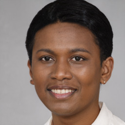 Joyful black young-adult female with short  black hair and brown eyes