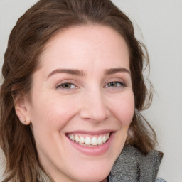 Joyful white young-adult female with medium  brown hair and blue eyes