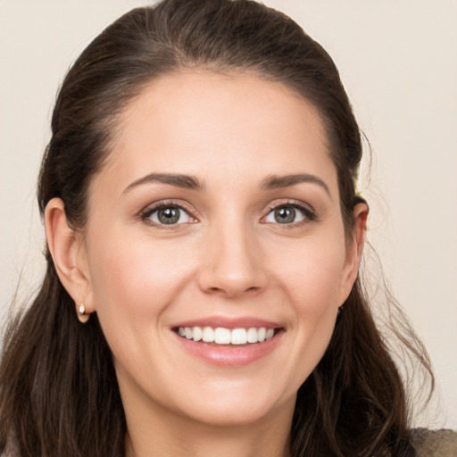 Joyful white young-adult female with long  brown hair and grey eyes