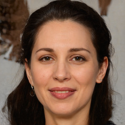 Joyful white adult female with medium  brown hair and brown eyes