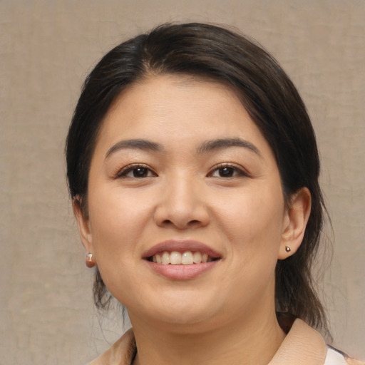 Joyful asian young-adult female with medium  brown hair and brown eyes