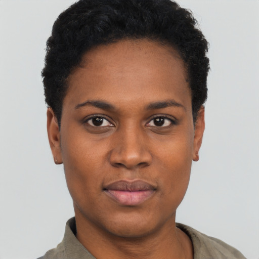 Joyful black young-adult female with short  black hair and brown eyes