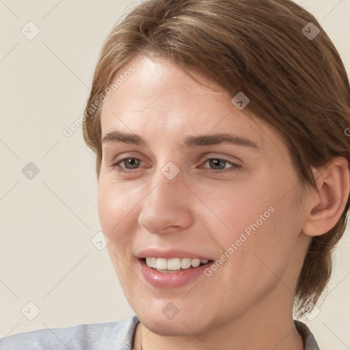 Joyful white young-adult female with medium  brown hair and grey eyes