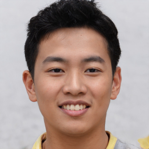 Joyful asian young-adult male with short  black hair and brown eyes