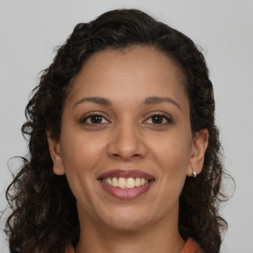 Joyful black young-adult female with medium  brown hair and brown eyes