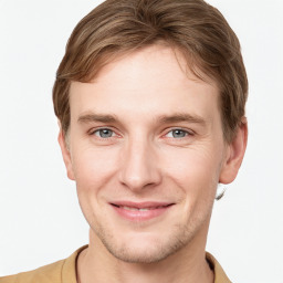Joyful white young-adult male with short  brown hair and grey eyes