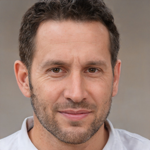 Joyful white adult male with short  brown hair and brown eyes